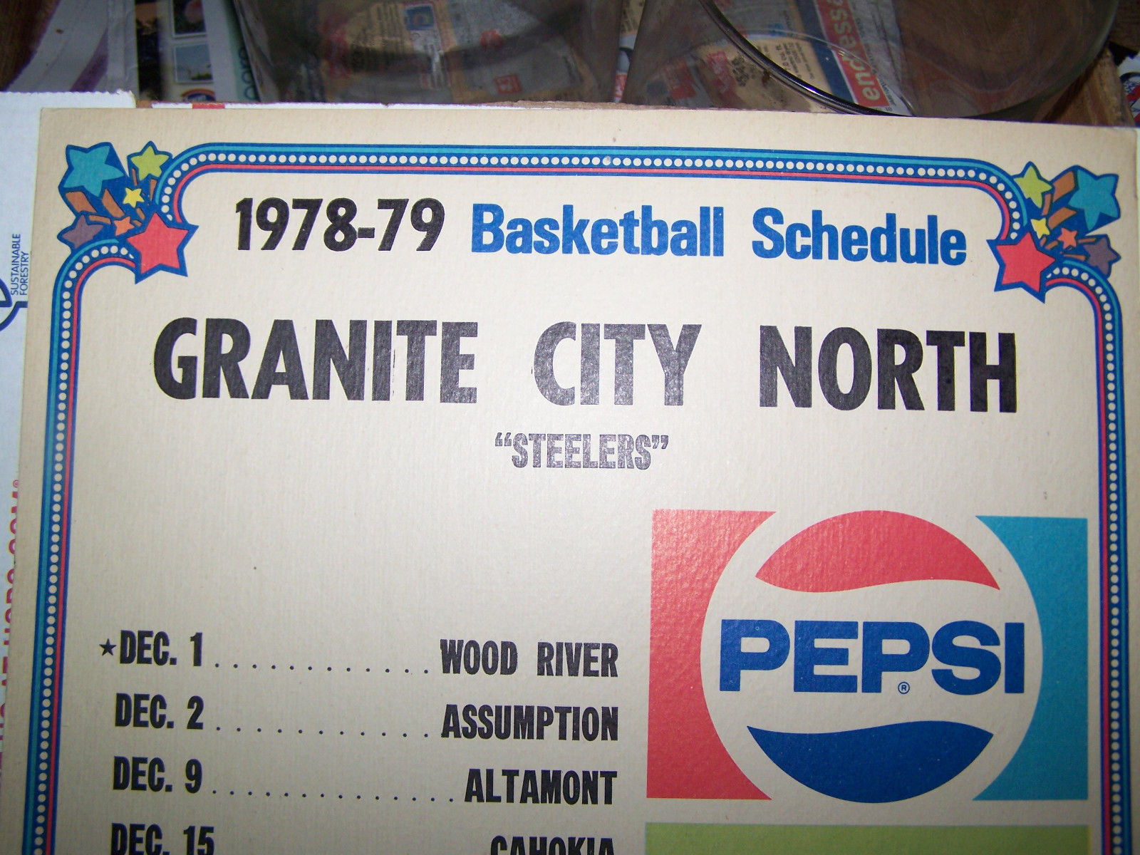 A Colored Version of the Bottle Cap Logo, Featured on a High School Basketball Schedule